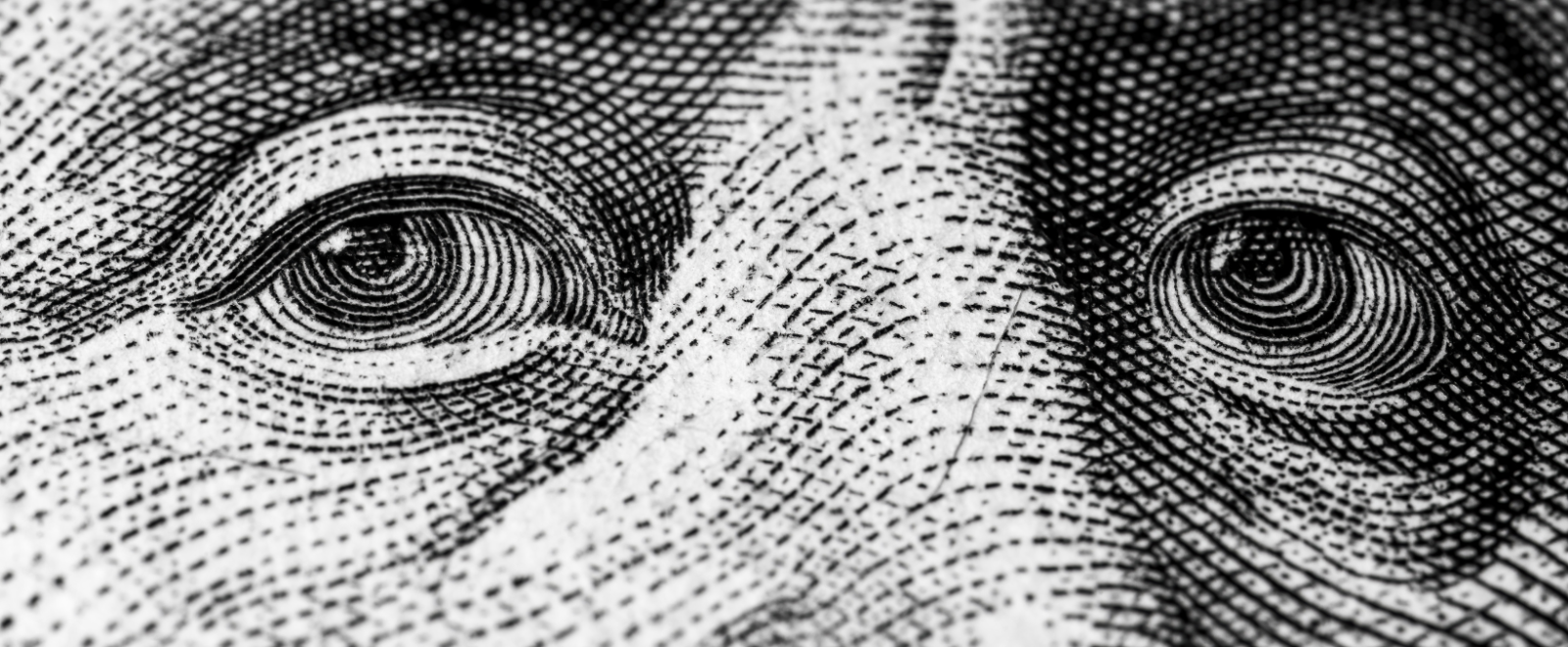close up of Ben Franklin's eyes on the $100 bill