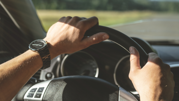 Hands on a steering wheel.