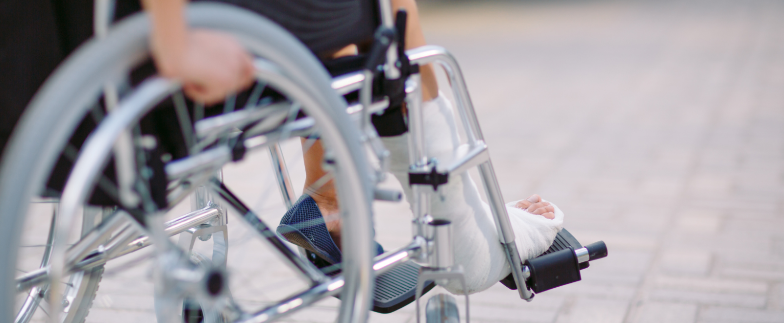 Person in wheelchair with a broken leg.
