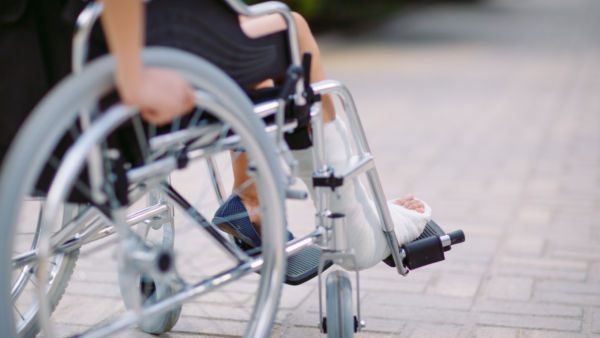 Person in wheelchair with a broken leg.